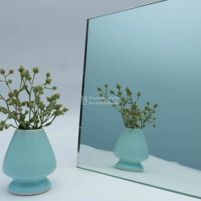 a clear mirror with reflection of flower jar