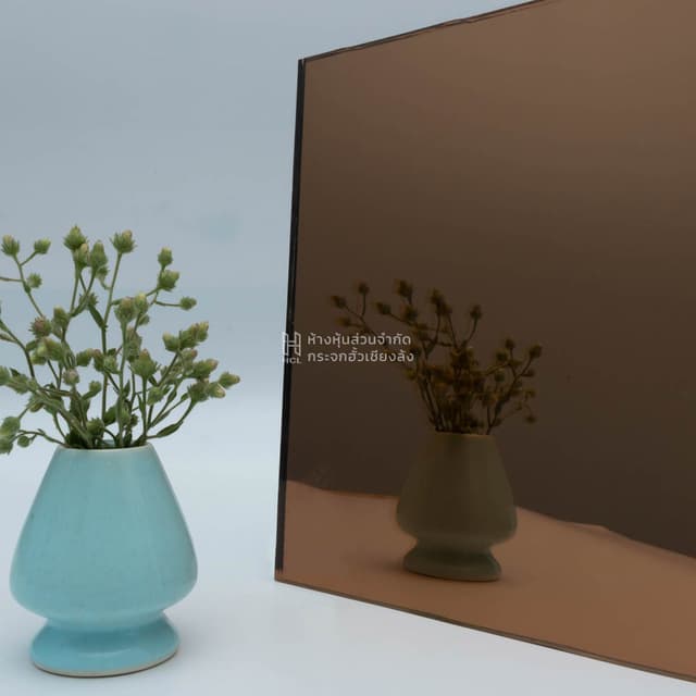 copper mirror with reflection of flower jar