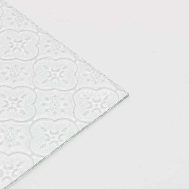 edge of clear floral patterned glass