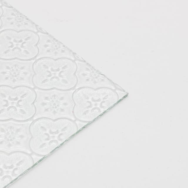 edge of clear floral patterned glass