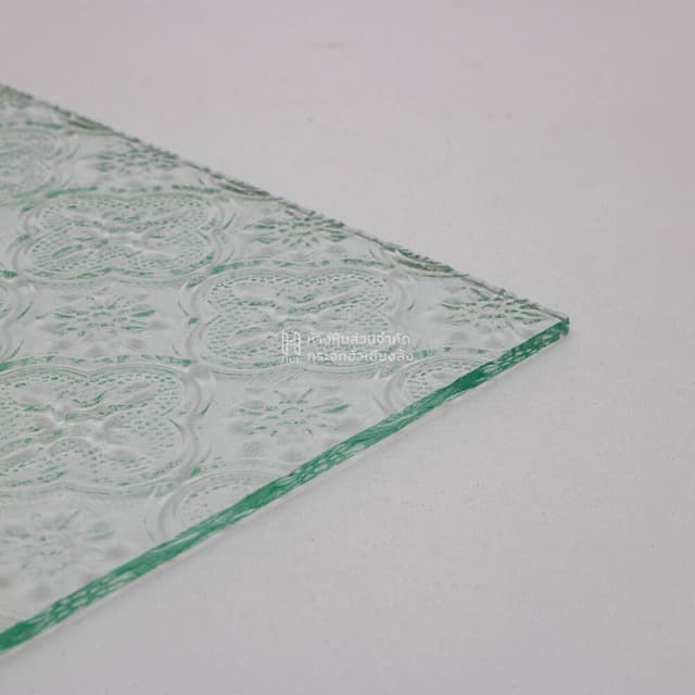 edge of clear floral patterned glass