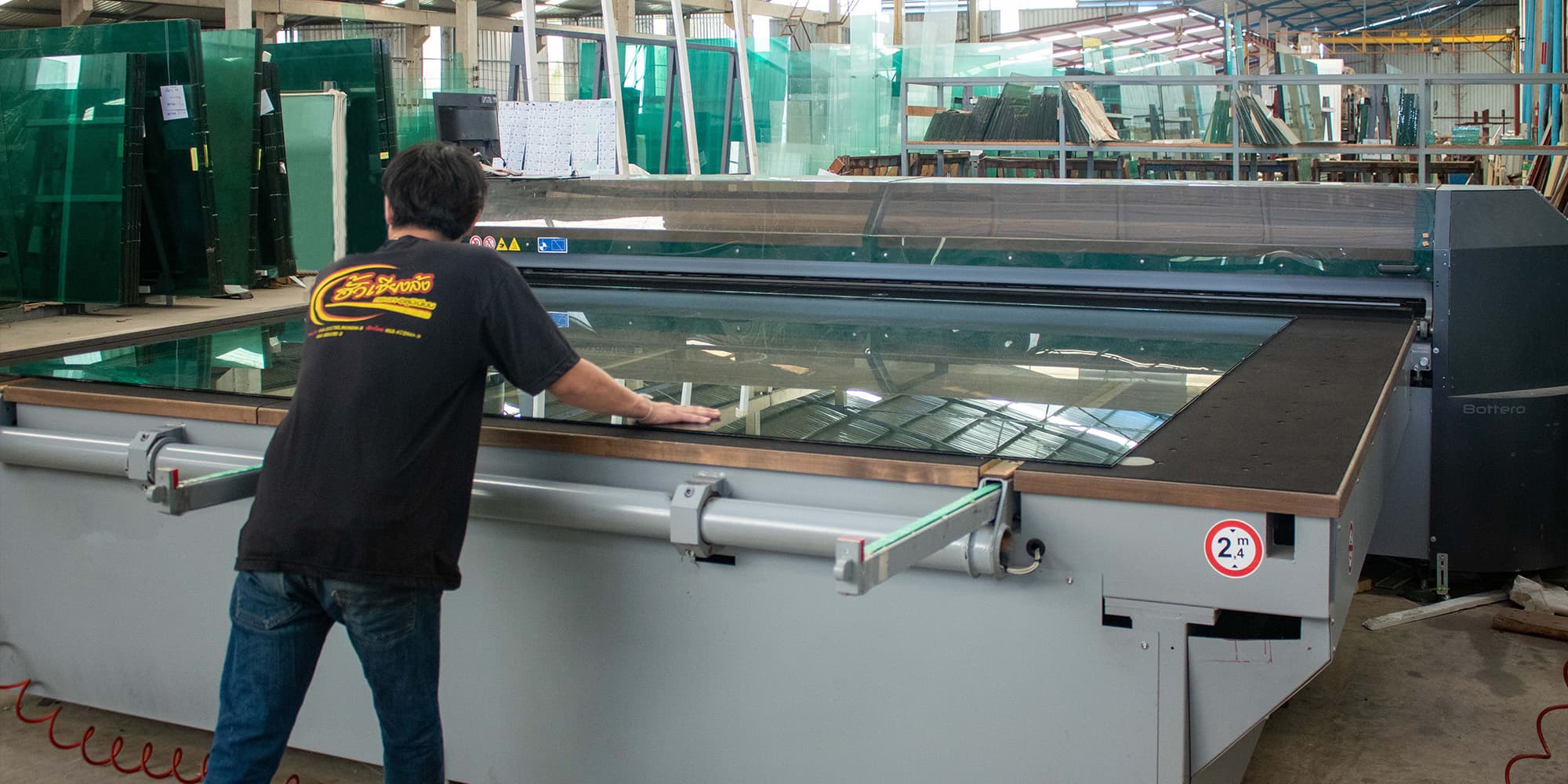 Officer feeding glass into cutting machine